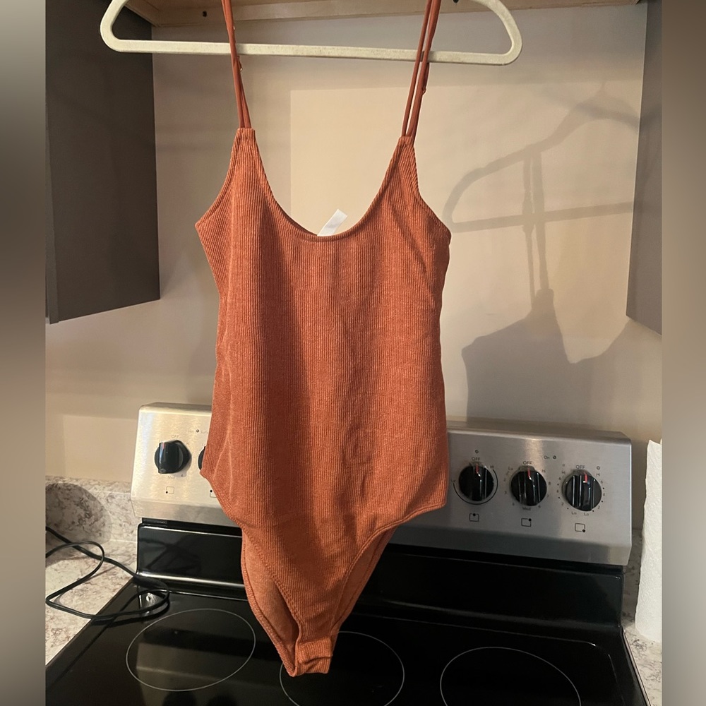 Spaghetti strap, rust colored bodysuit.